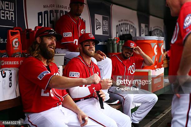 Jayson Werth and Bryce Harper of the Washington Nationals sit in the dugout prior to Game One of the National League Division Series against the San...