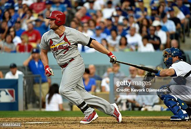 Matt Holliday of the St. Louis Cardinals hits a single in the seventh inning against the Los Angeles Dodgers during Game One of the National League...