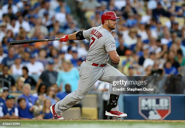 Matt Holliday of the St. Louis Cardinals hits a single in the seventh inning against the Los Angeles Dodgers during Game One of the National League...