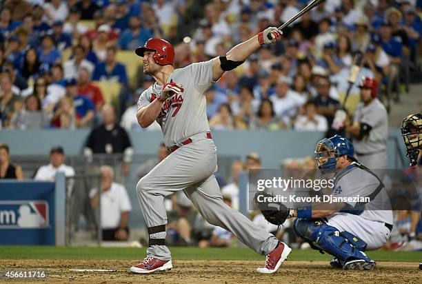 Matt Holliday of the St. Louis Cardinals hits a three run homerun in the seventh inning during Game One of the National League Division Series at...