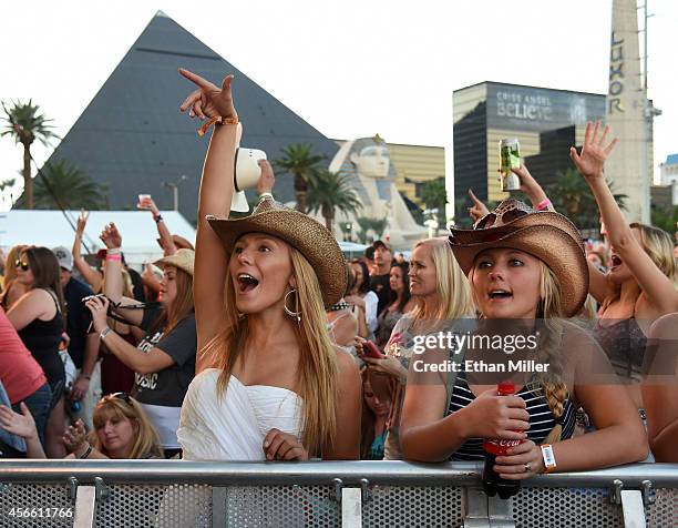 Taylor Gagon and Braxton Gibson, both of Utah, react as Randy Houser is introduced during the Route 91 Harvest country music festival at the MGM...