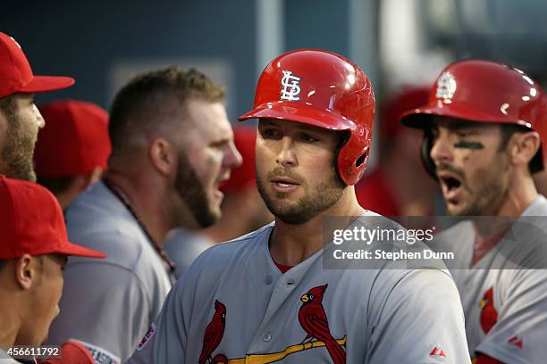 Matt Holliday of the St. Louis Cardinals celebrates his three run homerun with teammates in the seventh inning during Game One of the National League...