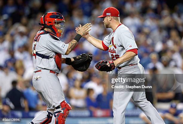 Closing pitcher Trevor Rosenthal of the St. Louis Cardinals celebrates with teammate catcher Yadier Molina after their 10-9 win over the Los Angeles...