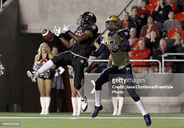 Defensive back Brandyn Thompson of the Ottawa Redblacks knocks down a pass intended for slotback Aaron Kelly of the Winnipeg Blue Bombers during a...