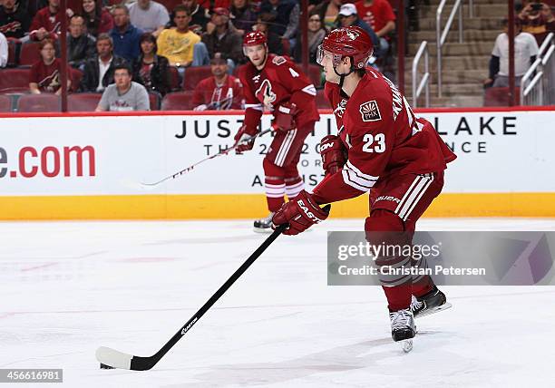 Oliver Ekman-Larsson of the Phoenix Coyotes skates with the puck during the NHL game against the New York Islanders at Jobing.com Arena on December...