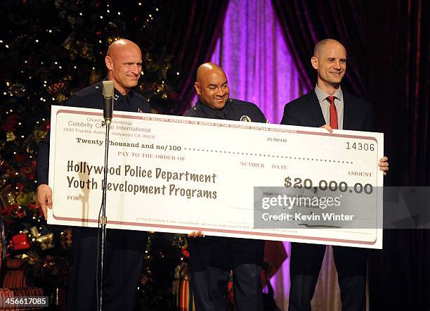 Hollywood Division Area Commander Peter Zarcone, Sgt. Darrell Davis, and Church of Scientology Celebrity Centre Vice President Greg LaClaire with the...