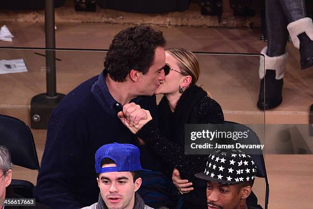 Olivier Sarkozy and Mary-Kate Olsen attend the Atlanta Hawks vs New York Knicks game at Madison Square Garden on December 14, 2013 in New York City.