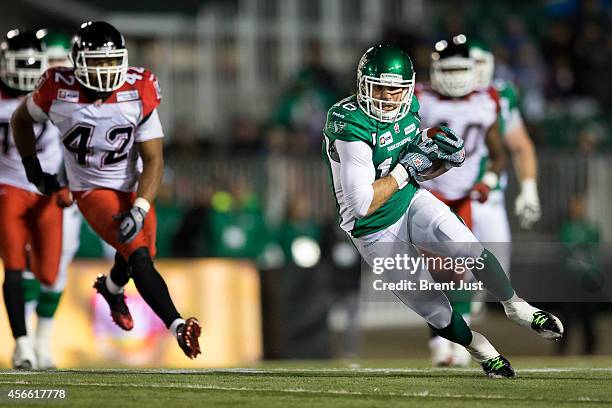 Brett Swain of the Saskatchewan Roughriders runs after a catch in a game between the Calgary Stampeders and Saskatchewan Roughriders in week 15 of...
