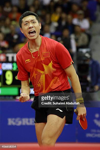 Xu Xin of China celebrates a winning point over Fan Zhengdong of China in the men's singles finals gold medal table tennis match on day fifteen of...