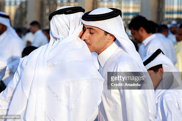 Muslims exchange greetings after performing Eid al-Adha prayer at the Ali Bin Ali Mosque in Doha, Qatar on the first day of Eid al-Adha, October...