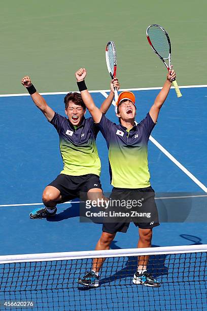 Kim Donghoon and Kim Beomjun of South Korea celebrate winning the Soft Tennis Men's Team Gold Medal Match competes against Hidenori Shinohara and...