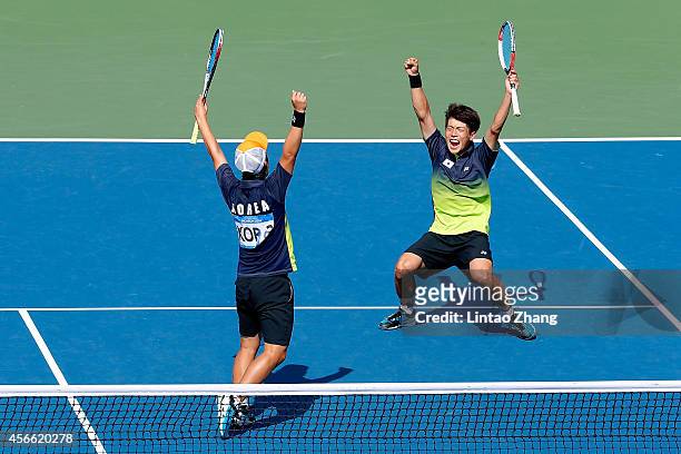 Kim Donghoon and Kim Beomjun of South Korea celebrate winning the Soft Tennis Men's Team Gold Medal Match competes against Hidenori Shinohara and...