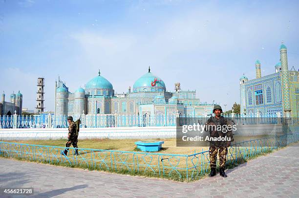 Security measures are taken outside the Blue Mosque when Muslims perform El al-Adha prayer in Mazar-i-Sharif, Afghanistan on October 4, 2014.