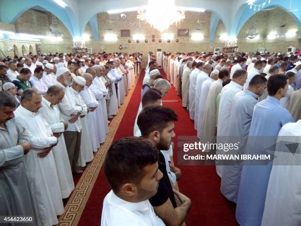 Iraqi Sunni Muslim worshipers attend morning prayer at a mosque in the northern city of Kirkuk on October 4 on the first day of the Muslim holiday of...