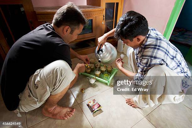 Afghan Ramazan Ali, a fruit seller right, and Asif Ali a policeman from Quetta, Pakistan both ethnic Hazaras seeking asylum, make tea at the house...