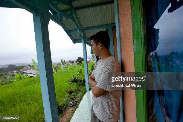 Shuhab Hussain, an ethnic Hazara student from Quetta Pakistan looks out from the the house he rents with 6 others December 14, 2013 in Cisarua,...