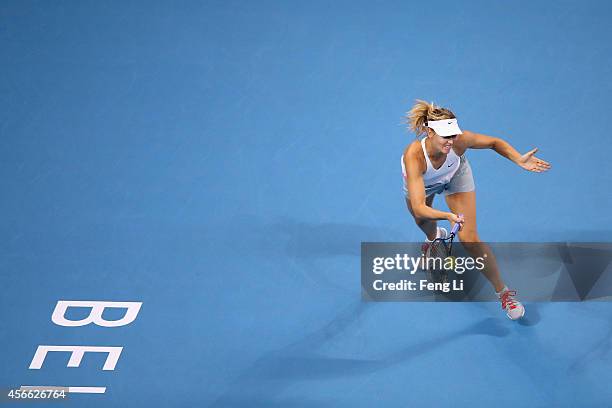 Maria Sharapova of Russia returns a shot during her semifinal match against Ana Ivanovic of Serbia during day eight of the China Open at the China...