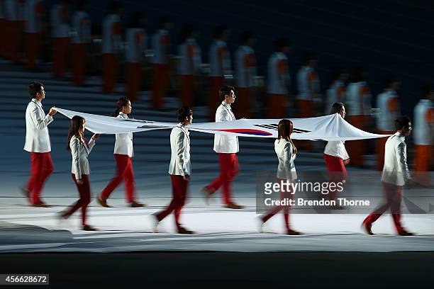 South Korean athletes carry their nations flag as part of the Closing Ceremony during day fifteen of the 2014 Asian Games at Incheon Asiad Main...