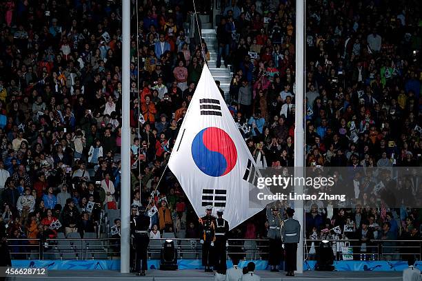 The South Korean flag is raised during the closing ceremony of the 2014 Asian Games at The Incheon Asiad Main Stadium on October 4, 2014 in Incheon,...