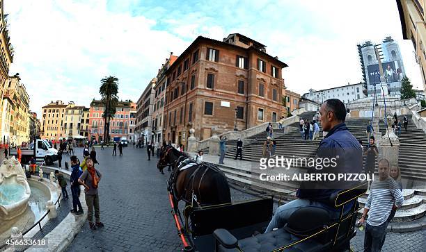 Angelo Sed, president of the Romans horse-drawn carriage drivers and his horse "Inventore" passes in front of the Spanish Steps at Piazza di Spagna...