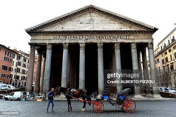 Angelo Sed, president of the Romans horse-drawn carriage drivers and his horse "Inventore" wait for clients in front of the Pantheon on October 2,...