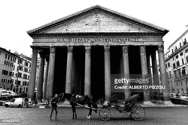 Angelo Sed, president of the Romans horse-drawn carriage drivers and his horse "Inventore" wait for clients in front of the Pantheon on October 2,...