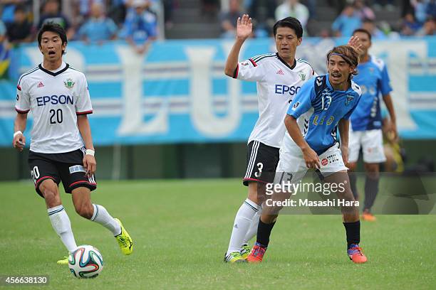 Yosuke Nozaki of Yokohama FC and Hayuma Tanaka of Matsumoto Yamaga compete for the ball during the J.League second division match between Yokohama FC...