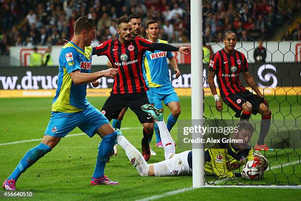 Goalkeeper Timo Horn of Koeln catches the ball behind the goal line for Frankfurt's third goal during the Bundesliga match between Eintracht...