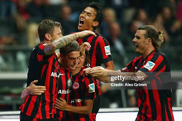 Bastian Oczipka of Frankfurt celebrates his team's third goal with team mates Marco Russ, Takashi Inui, Makoto Hasebe and Alexander Meier during the...