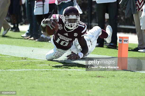 Brandon Holloway of the Mississippi State Bulldogs reaches for the goal line over Armani Watts of the Texas A&M Aggies during the third quarter of a...