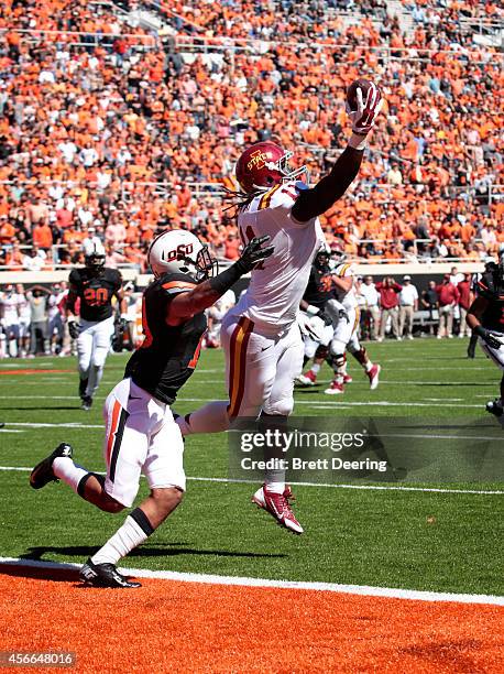 Tight end E.J. Bibbs of the Iowa State Cyclones catches a touchdown pass in front of safety Jordan Sterns of the Oklahoma State Cowboys October 4,...