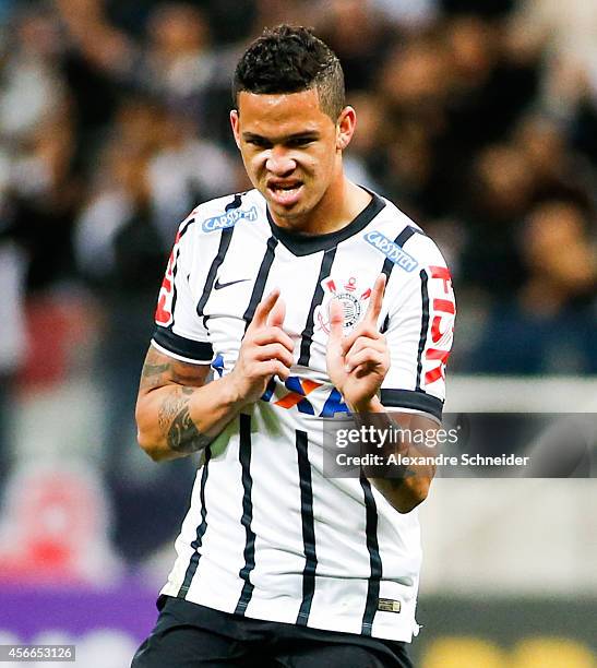 Luciano of Corinthians celebrates their thirth goal during the match between Corinthians and Sport Recife for the Brazilian Series A 2014 at Arena...