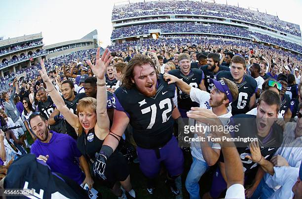 Guard Bobby Thompson of the TCU Horned Frogs celebrates with fans on the field after the Horned Frogs beat the Oklahoma Sooners 37-33 at Amon G....