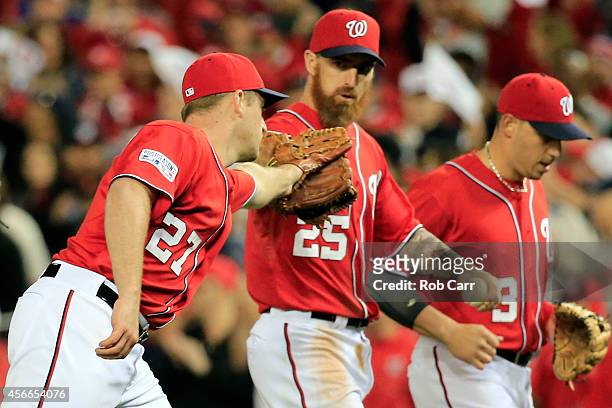 Jordan Zimmermann of the Washington Nationals celebrates with Adam LaRoche after the third out in the eighth inning against the San Francisco Giants...