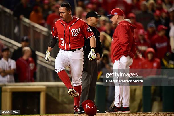 Asdrubal Cabrera of the Washington Nationals gets ejected by home plate umpire Vic Carapazza after arguing a strike call in the tenth inning against...