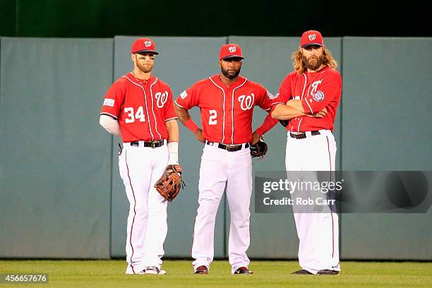 Bryce Harper, Denard Span and Jayson Werth of the Washington Nationals look on during a pitching change in the twelfth inning against the San...