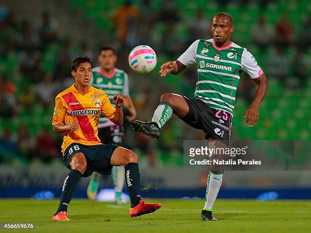 Ribair Rodriguez of Santos tries to control the ball as Erick Aguirre of Morelia looks during a match between Santos Laguna and Morelia as part of...