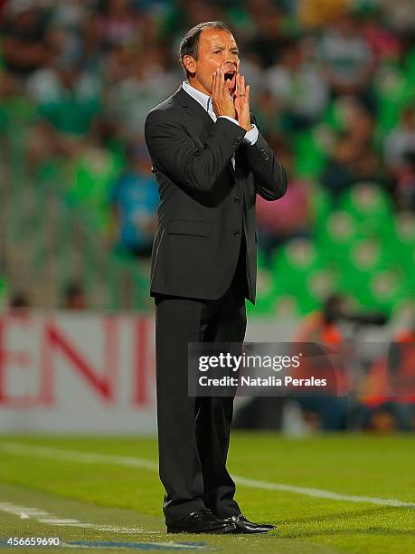 Head coach Jose Cruz of Morelia gives instructions to his players during a match between Santos Laguna and Morelia as part of 12th round Apertura...