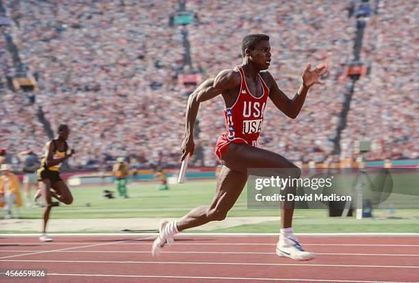 Carl Lewis of the USA runs the anchor leg of the Men's 4x100m relay race of the Track and Field competition of the 1984 Olympic Games held on August...