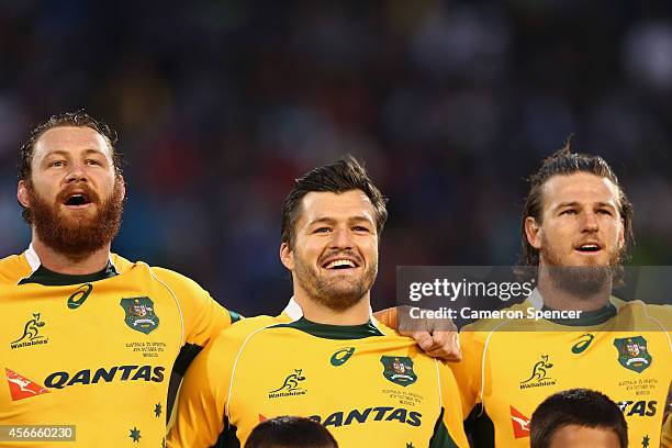 Scott Higginbotham, Adam Ashley-Cooper and Rob Horne of the Wallabies sing the Australian national anthem during The Rugby Championship match between...