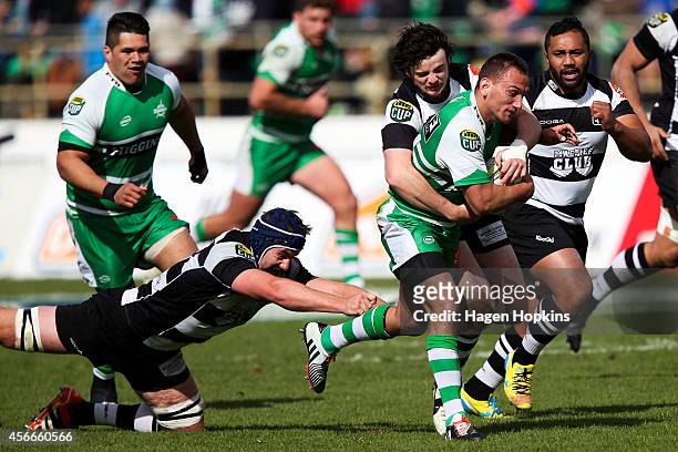 Aaron Cruden of Manawatu is tackled by Mark Abbott and Richard Buckman of Hawke's Bay during the round 8 ITM Cup match between Manawatu and Hawke's...