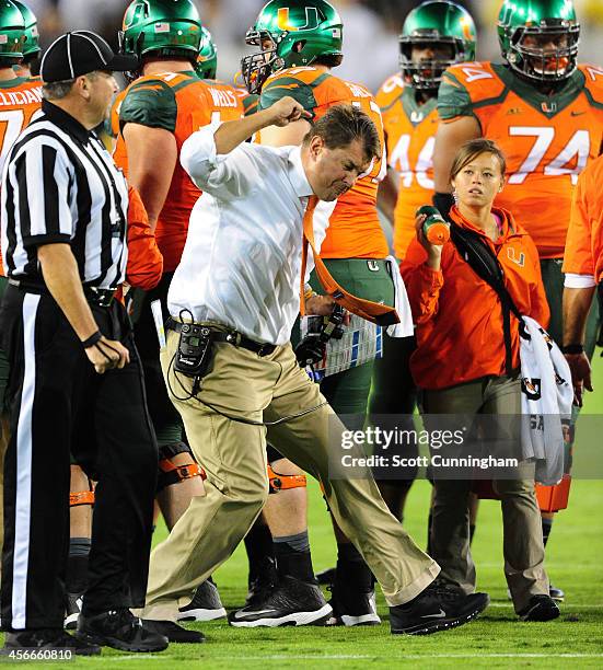 Head Coach Al Golden of the Miami Hurricanes disputes a call with an official during the game against the Georgia Tech Yellow Jackets at Bobby Dodd...