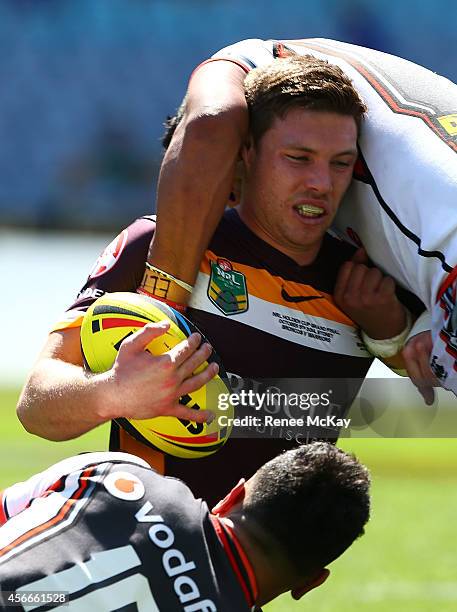 Tom Opacic of the Broncos is tackled during the 2014 Under 20's Holden Cup Grand Final match between the Brisbane Broncos and the New Zealand...