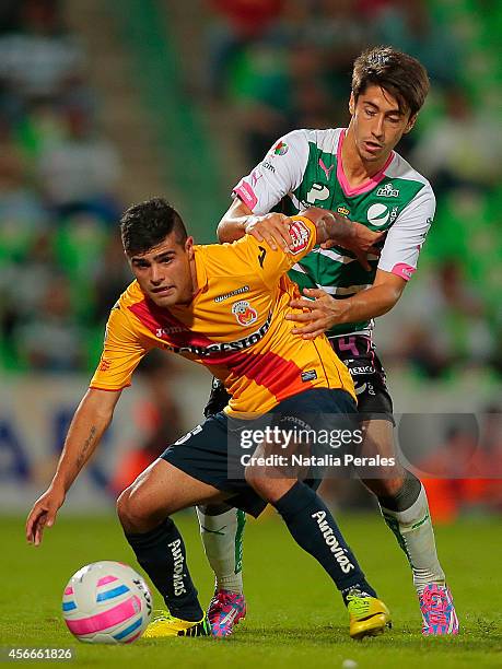 Diego Alaniz of Morelia protects the ball from the mark of and Javier Abella of Santos during a match between Santos Laguna and Morelia as part of...