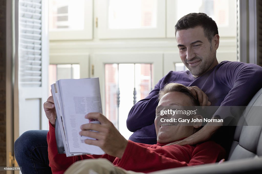 Two gay men relaxing on sofa