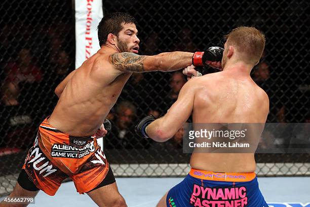 Raphael Assuncao of Brazil punches Bryan Caraway in their bantamweight bout at the Scotiabank Centre on October 4, 2014 in Halifax, Nova Scotia,...