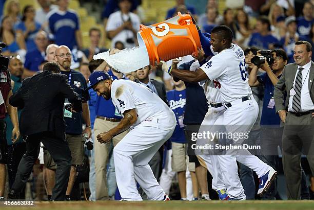 Yasiel Puig of the Los Angeles Dodgers dumps water on Matt Kemp after their 3-2 win over the St. Louis Cardinals in Game Two of the National League...