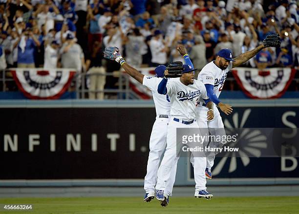 Matt Kemp, Carl Crawford and Yasiel Puig of the Los Angeles Dodgers celebrates their team's 3-2 win over the St. Louis Cardinals in Game Two of the...