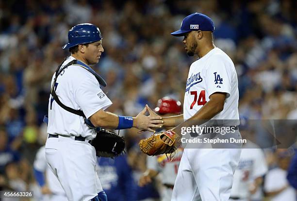 Closing pitcher Kenley Jansen and catcher A.J. Ellis of the Los Angeles Dodgers celebrates after their team's 3-2 win over the St. Louis Cardinals in...