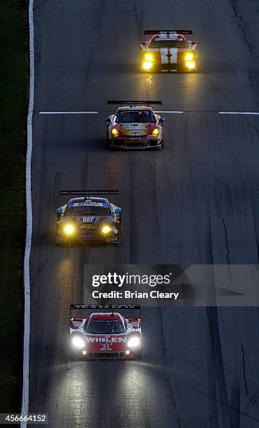 Pack of cars races down a hill at Petit Le Mans at Road Atlanta on October 4, 2014 in Braselton, Georgia.